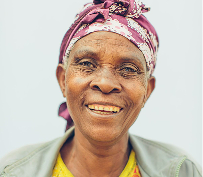 Smiling elderly woman representing the Faith pillar of Good Job Ministry