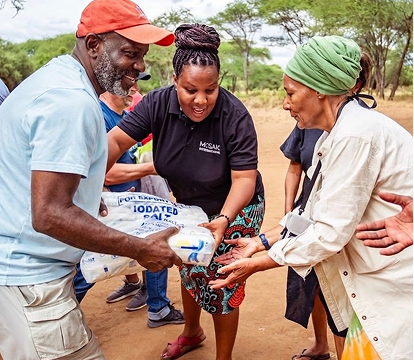 Volunteers distributing food supplies to community members